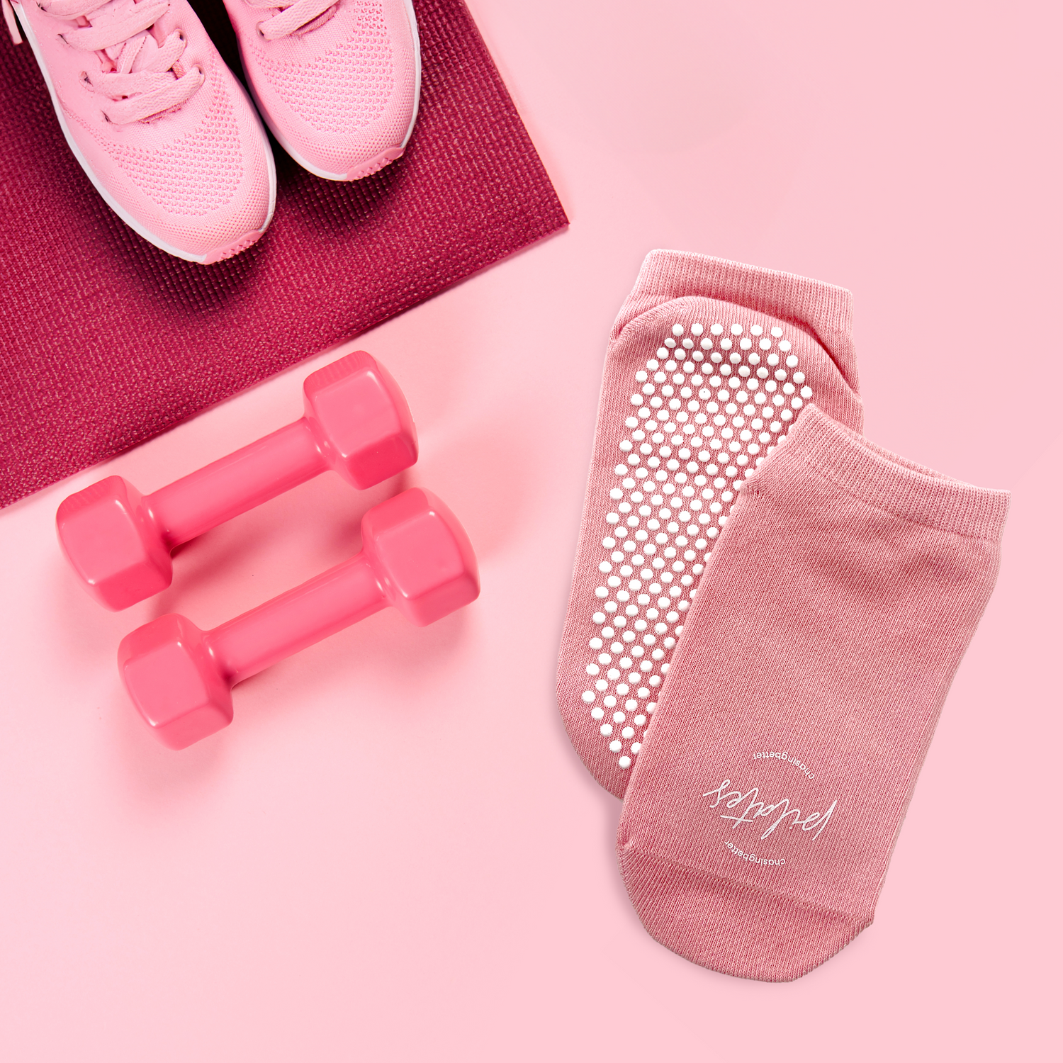 a pair of pink Pilates grip socks with non-slip silicone grips